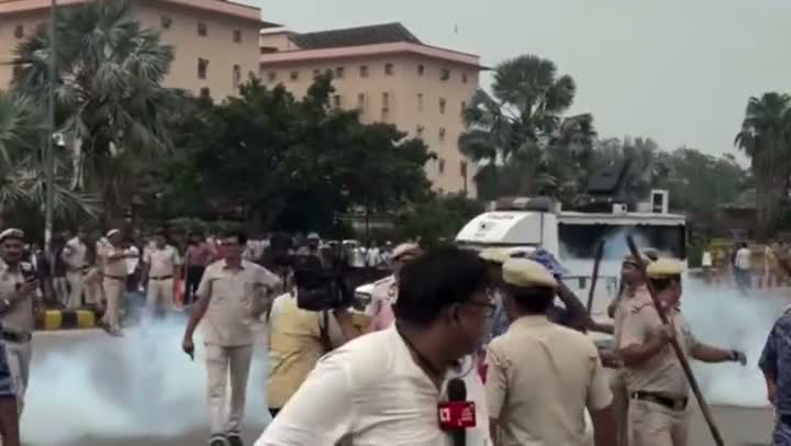 Riot police mass amid tear-gas haze