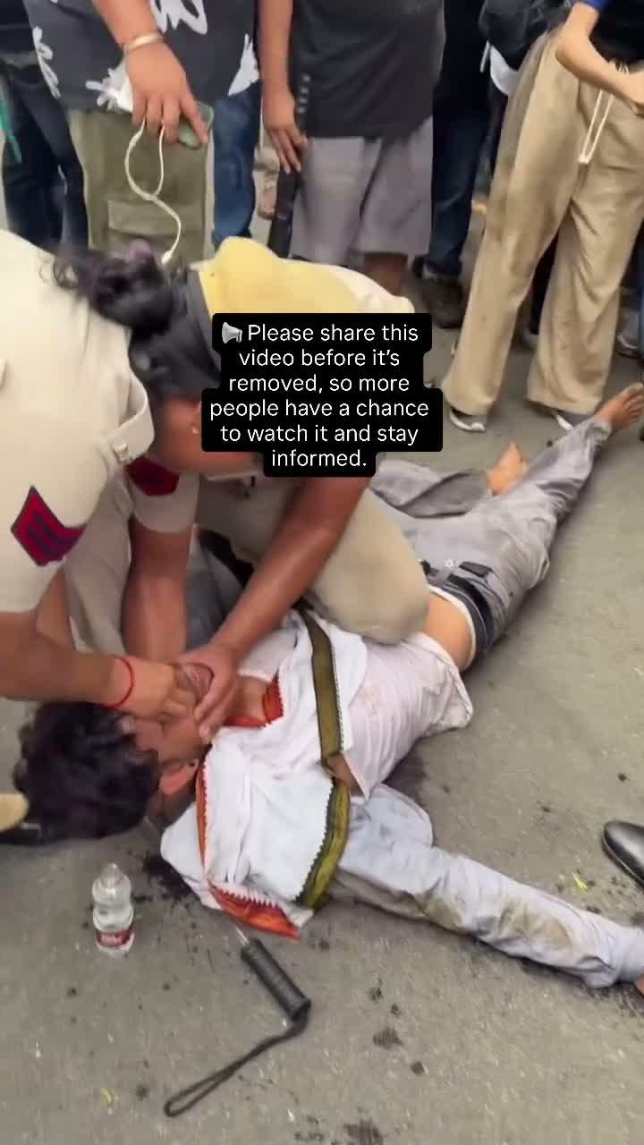 Crowd gathers near police; caption urges sharing before removal