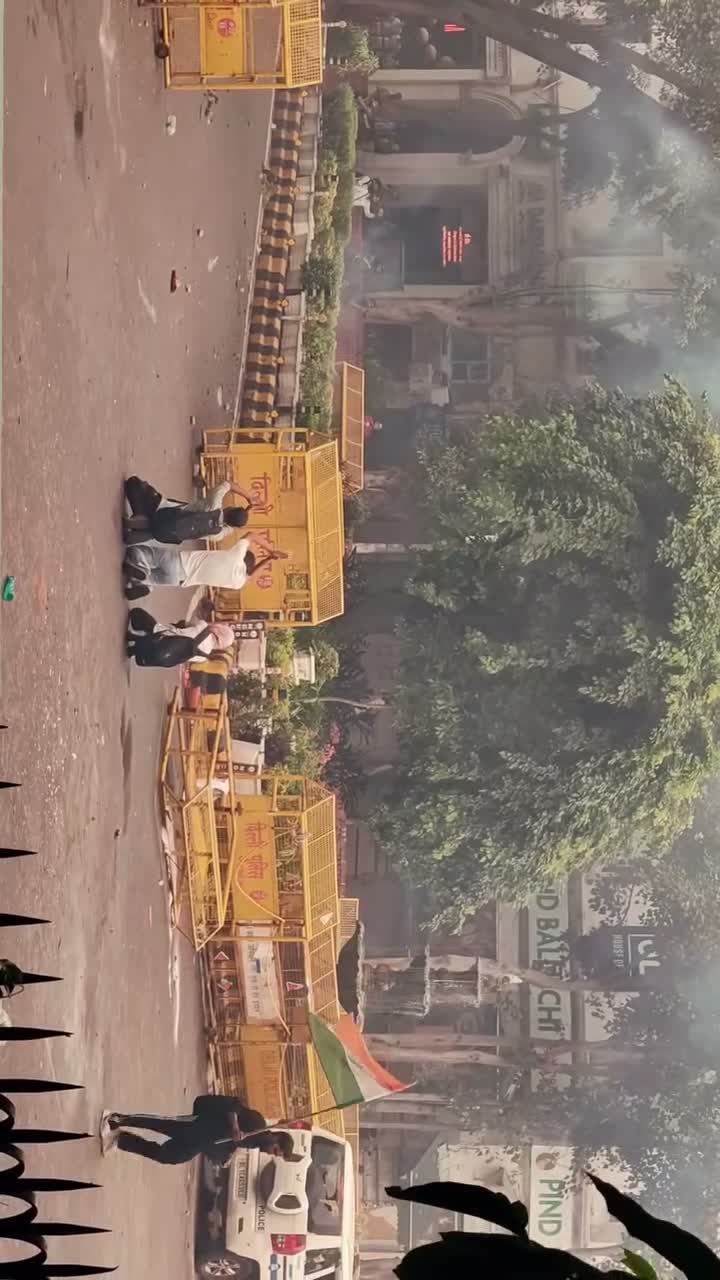 Smoke haze near police barricades on a Delhi street