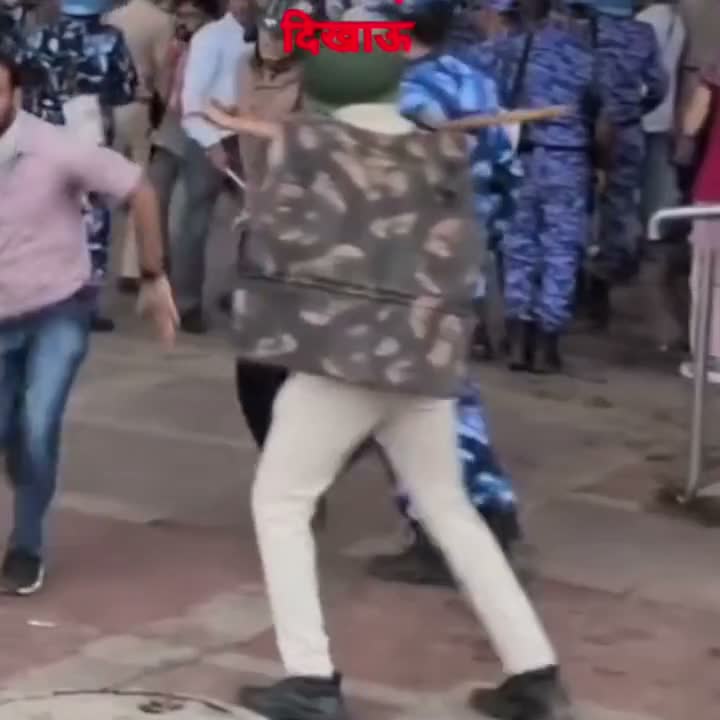 Man runs past riot police amid a chaotic scene; partial caption visible
